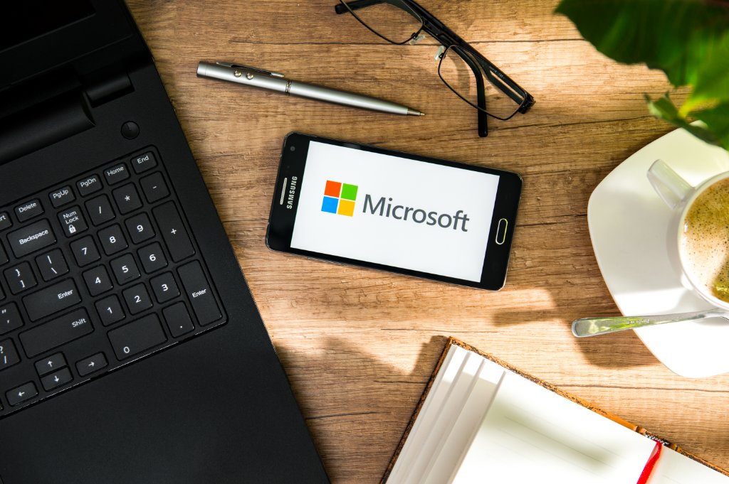 Microsoft logo on tablet with business workspace